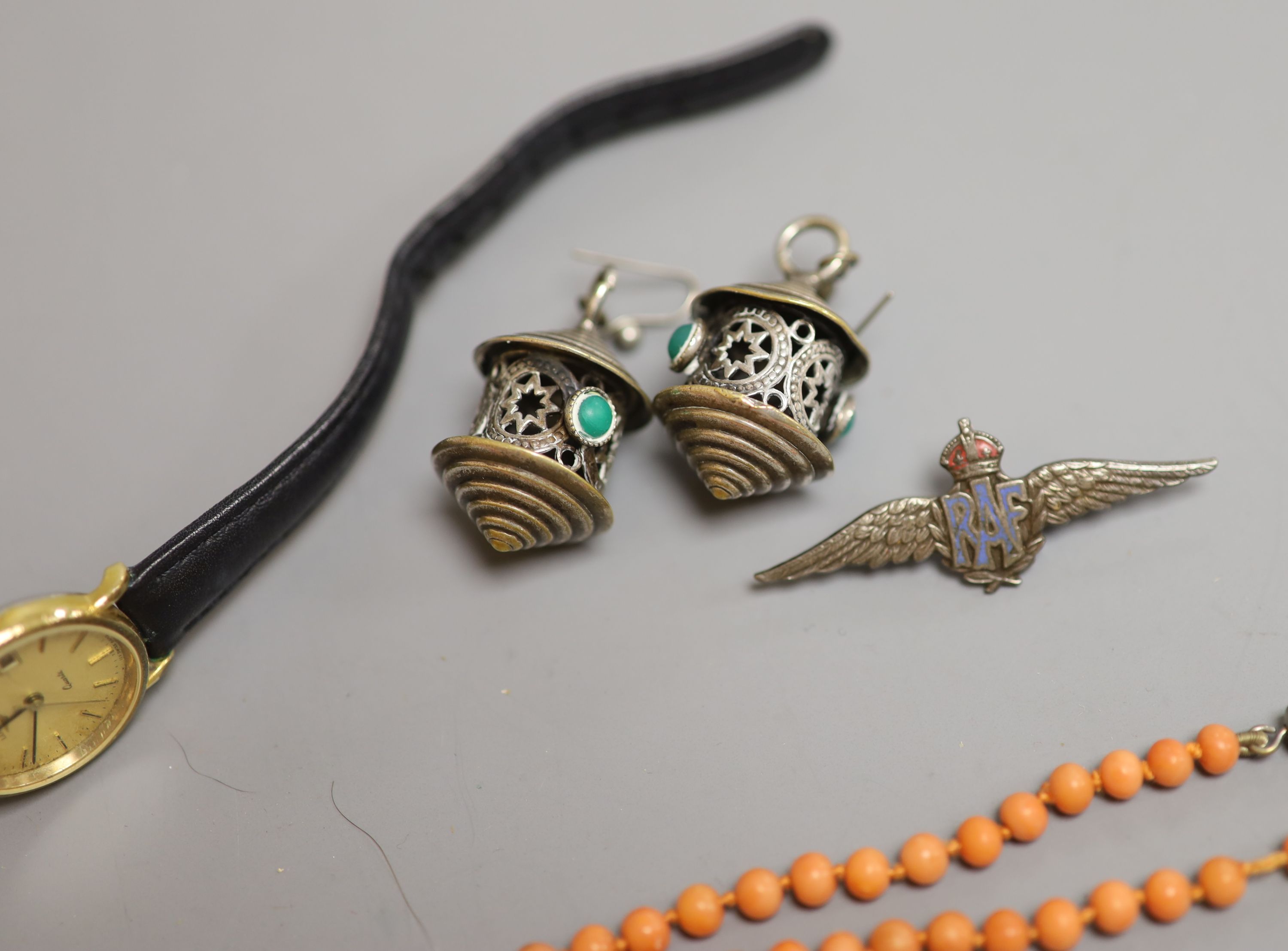 A lady's Longines gold plated and steel quartz wristwatch, one other watch, a coral bead necklace, badges etc.
